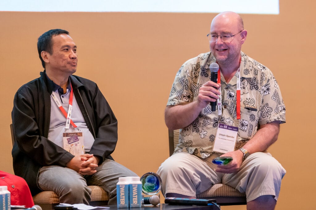 ISIF Asia awardees Dr Charles Lim and Dr Ulrich Speidel during a panel discussion at APNIC 54.