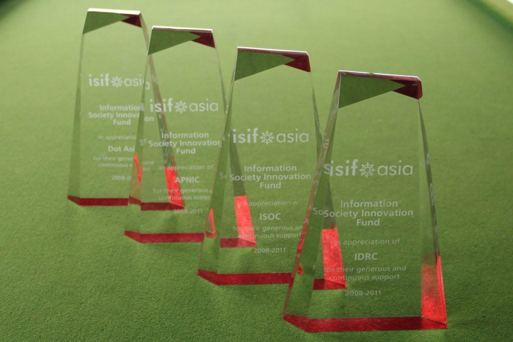 Four glass ISIF Asia award trophies.