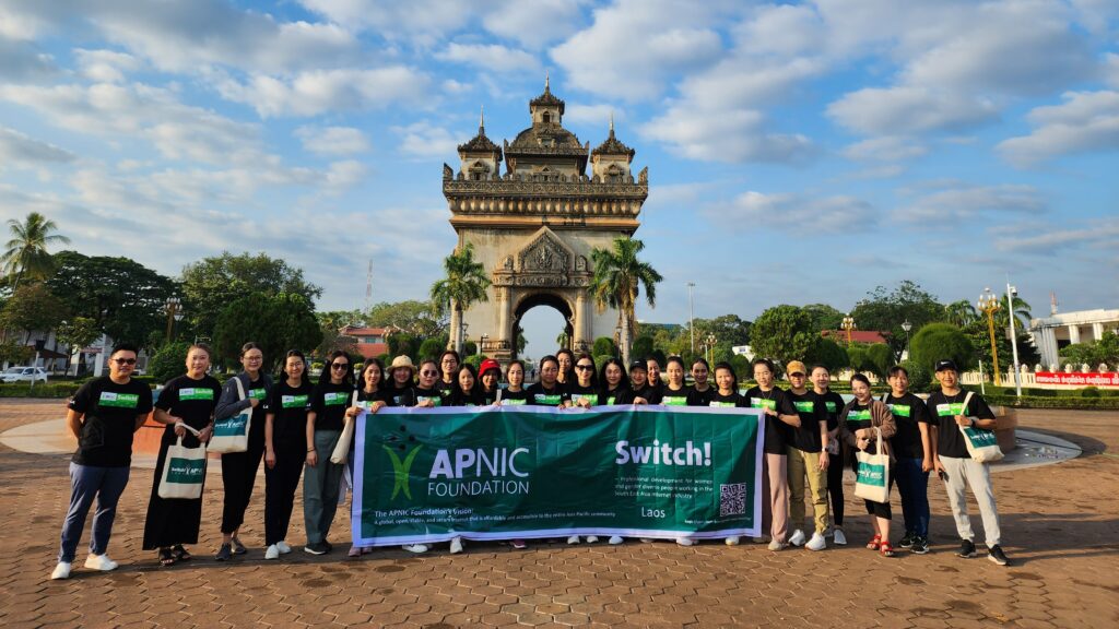 A group of Switch! participants stand outside in front of a fountain and archway.