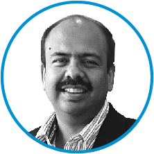 An image of committee member Sharad Sanghi in black and white, inside a blue circle.
