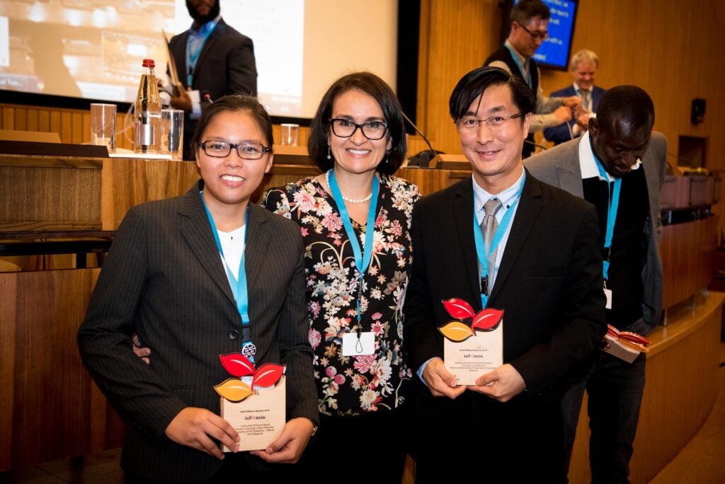 ISIF Asia 2018 award winners, the University of the Philippines (represented by Claire Barela, left) and Myanmar Book Aid Preservation Foundation (represented by Dr. Thant Thaw Kaung, right) and Foundation Head of Programs and Partnerships Sylvia Cadena (center).